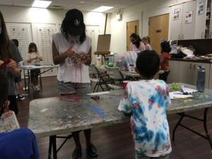 Counselor helping child with art project