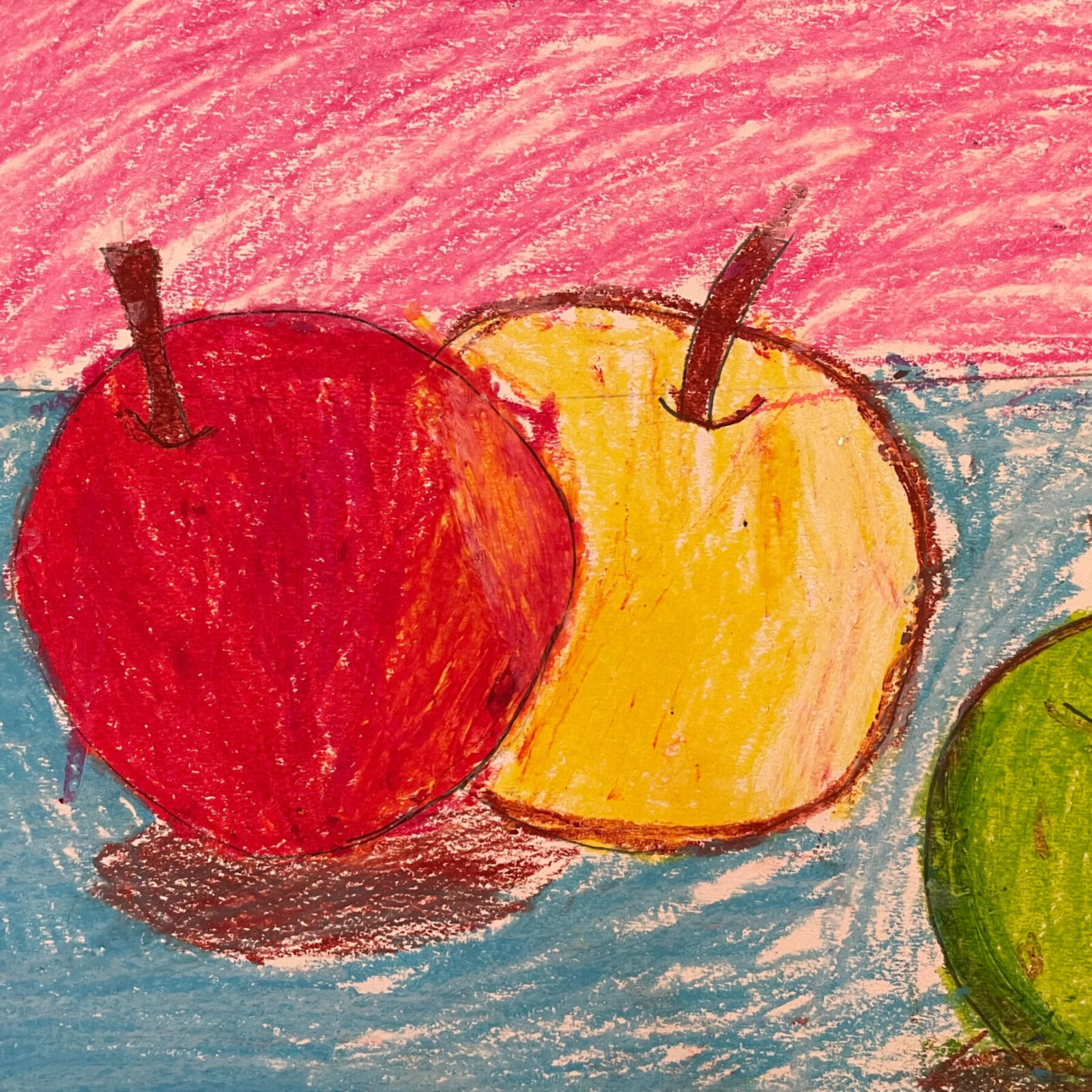 Red, yellow and green apples on a blue table with a red background