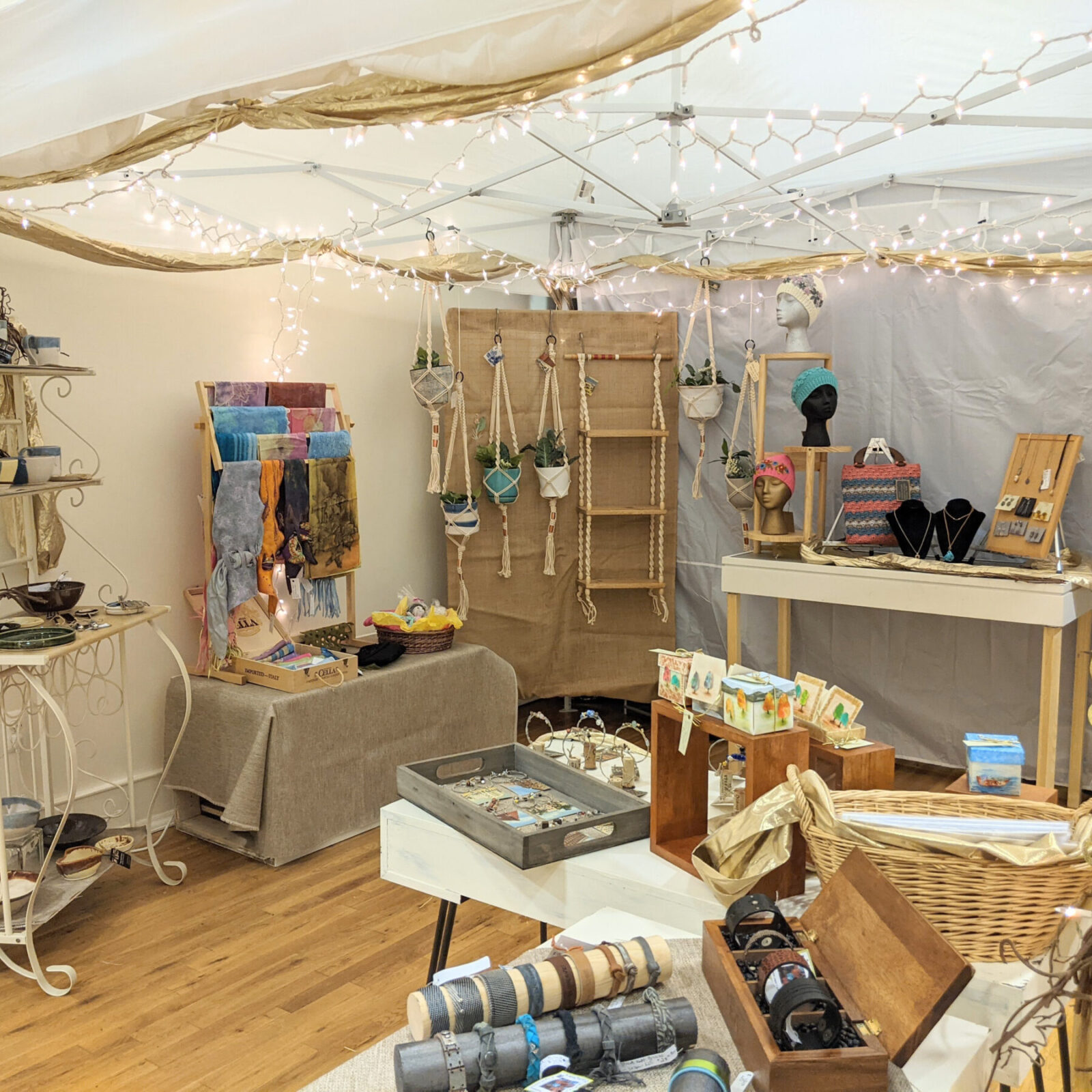 White pop-up tent filled with artisan items