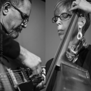 black and white composite photo of a man playing guitar and a woman playing upright bass