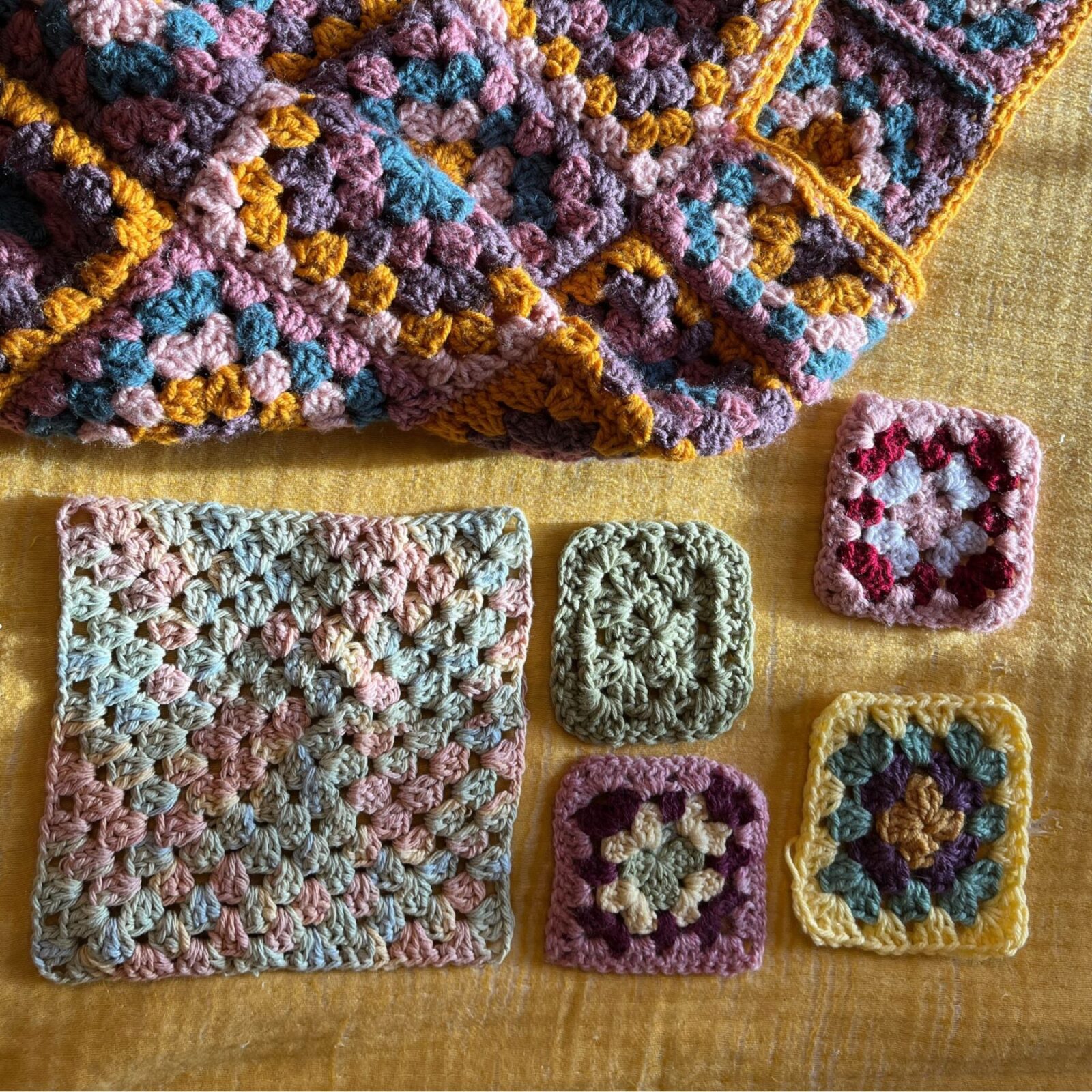 crochet granny squares of a variety of colors